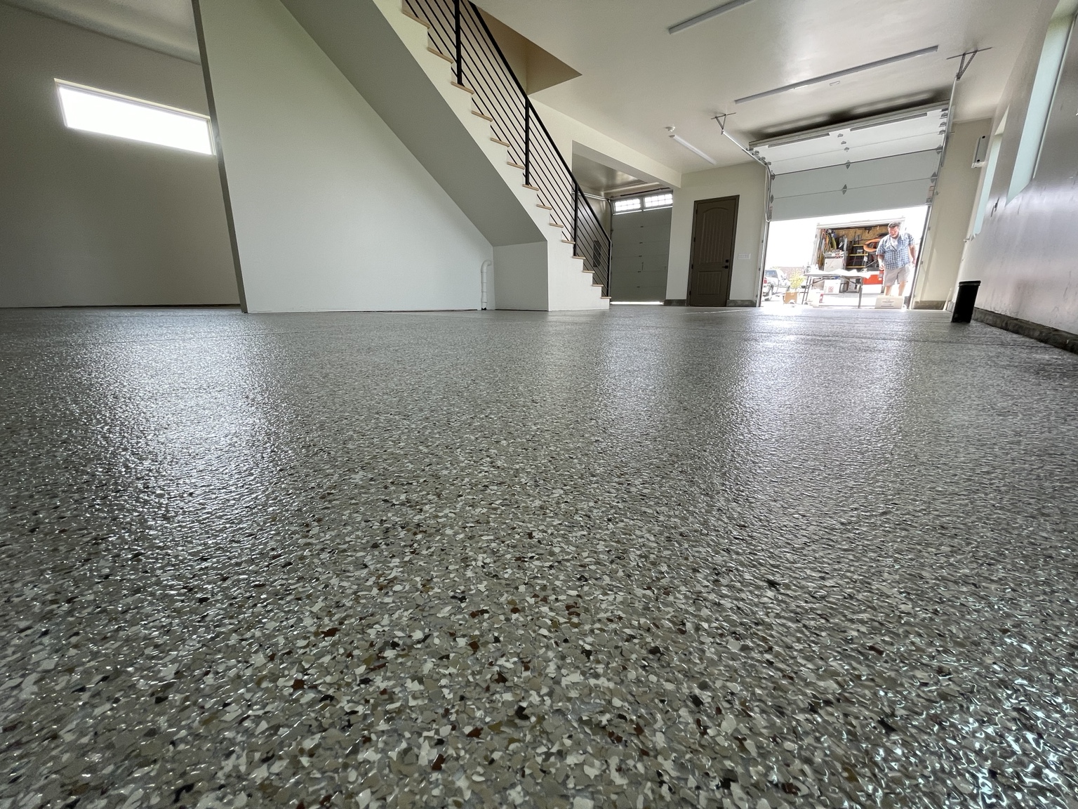 Coastal Concrete Coatings Texas finished gray flake floor in a residential garage